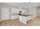 Well-lit kitchen featuring white cabinets, stainless steel appliances, and a spacious island at 2130 Revere St, North Las Vegas, NV 89030