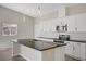 Modern kitchen with white cabinets, stainless steel appliances, and a large center island at 2130 Revere St, North Las Vegas, NV 89030