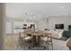 Open-concept living room and kitchen with modern lighting fixtures and wood flooring at 2130 Revere St, North Las Vegas, NV 89030