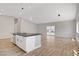 Bright open-concept area with kitchen island and wood floors at 2130 Revere St, North Las Vegas, NV 89030