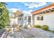Cozy backyard featuring river rock landscaping, a covered patio, and mature foliage at 2204 Plaza De La Candela, Las Vegas, NV 89102