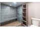 Luxurious bathroom with a glass-enclosed shower featuring green marble walls and a built-in shower bench at 2204 Plaza De La Candela, Las Vegas, NV 89102