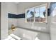Bright bathroom features a soaking tub with gold fixtures and blue tiled accent wall at 2204 Plaza De La Candela, Las Vegas, NV 89102