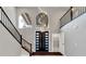 Foyer featuring high ceilings, grand chandelier, staircase, and a modern entry door at 2204 Plaza De La Candela, Las Vegas, NV 89102