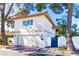 Two-story stucco home featuring a garage and private gated entrance at 2204 Plaza De La Candela, Las Vegas, NV 89102