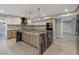 Modern kitchen featuring a marble island, updated appliances, and stylish lighting at 2204 Plaza De La Candela, Las Vegas, NV 89102