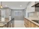 Modern kitchen featuring marble island, wood cabinets, white countertops, and stainless steel appliances at 2204 Plaza De La Candela, Las Vegas, NV 89102