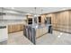 Stunning kitchen with a unique marble island, stainless steel appliances and wooden cabinetry at 2204 Plaza De La Candela, Las Vegas, NV 89102