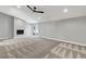 Open living room has neutral carpet, a modern ceiling fan, and sliding glass doors to the exterior at 2204 Plaza De La Candela, Las Vegas, NV 89102