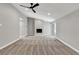 The open living room has neutral carpet, a modern ceiling fan, and sliding glass doors to the exterior at 2204 Plaza De La Candela, Las Vegas, NV 89102