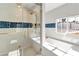 Luxurious shower features a glass door, blue accent tile, and gold shower hardware at 2204 Plaza De La Candela, Las Vegas, NV 89102