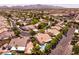 Aerial view of a residential area, showcasing the architectural styles, green spaces, and local parking amenities at 2547 Serenity Hollow Dr, Henderson, NV 89052