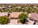 Aerial view of a well-maintained home with a three-car garage, mature trees, and landscaping at 2547 Serenity Hollow Dr, Henderson, NV 89052