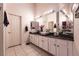 Bright bathroom features dual sinks, modern fixtures, and a large mirror at 2547 Serenity Hollow Dr, Henderson, NV 89052