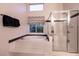Bright bathroom features a shower and tub combo with black and white trim at 2547 Serenity Hollow Dr, Henderson, NV 89052