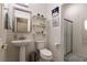 Bathroom features tiled shower, shelves, a toilet, and a pedestal sink at 2547 Serenity Hollow Dr, Henderson, NV 89052