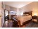 Cozy bedroom with a large bed, hardwood floors, and natural light at 2547 Serenity Hollow Dr, Henderson, NV 89052