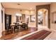 Open concept dining room with tile and wood floors, an elegant light fixture, and a view of the living room at 2547 Serenity Hollow Dr, Henderson, NV 89052