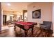 Game room showcasing the pool table, adjacent dining room, and natural light at 2547 Serenity Hollow Dr, Henderson, NV 89052