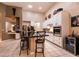 Open kitchen with a center island, barstool seating, and stainless steel appliances at 2547 Serenity Hollow Dr, Henderson, NV 89052