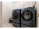 Laundry room features modern appliances with tile flooring and white cabinetry at 2547 Serenity Hollow Dr, Henderson, NV 89052