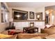 Inviting living room featuring a fireplace, a large television and a neutral color palette at 2547 Serenity Hollow Dr, Henderson, NV 89052
