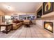Comfortable living room with tile floors, a fireplace, a large sectional, and natural lighting at 2547 Serenity Hollow Dr, Henderson, NV 89052