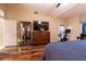 Comfortable bedroom with wood floors, a large dresser, and a ceiling fan at 2547 Serenity Hollow Dr, Henderson, NV 89052