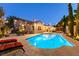 Backyard pool with beautiful outdoor lighting, seating, and landscaping at 2547 Serenity Hollow Dr, Henderson, NV 89052