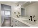 Elegant bathroom featuring double sinks, white cabinetry, and a large mirror at 2725 S Nellis Blvd # 2036, Las Vegas, NV 89121
