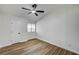 Bright bedroom featuring wood-look floors, a ceiling fan, and a large window at 2725 S Nellis Blvd # 2036, Las Vegas, NV 89121