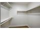 Spacious walk-in closet with white shelving and wood-look flooring, ready for organization at 2725 S Nellis Blvd # 2036, Las Vegas, NV 89121