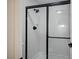 Modern bathroom shower with black trim and updated fixtures, featuring white tile at 2725 S Nellis Blvd # 2036, Las Vegas, NV 89121