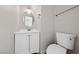 Bathroom with a white vanity, round mirror, and toilet at 2834 Crystal Lantern Dr, Henderson, NV 89074
