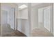 Hallway with skylight featuring modern trim and neutral carpet leading to bedrooms at 2834 Crystal Lantern Dr, Henderson, NV 89074