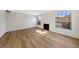 Inviting living room featuring wood floors, a fireplace, and bright windows for natural light at 2834 Crystal Lantern Dr, Henderson, NV 89074