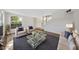 Bright, staged living room with large window, cozy seating, and modern decor for a welcoming ambiance at 2834 Crystal Lantern Dr, Henderson, NV 89074