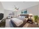 Luxurious staged primary bedroom with a plush bed, accent chairs, and large windows at 2834 Crystal Lantern Dr, Henderson, NV 89074