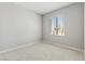 Cozy bedroom with neutral carpet and a window offering natural light, creating a serene space at 3220 Lahontan St, North Las Vegas, NV 89032