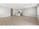 Bright and spacious living area featuring modern light gray walls and stylish wood-look flooring throughout at 3228 Lahontan St, North Las Vegas, NV 89032