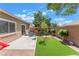 Private backyard boasts a patio area and artificial turf, creating a serene outdoor living space at 329 Gemstone Hill Ave, North Las Vegas, NV 89031