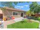 Charming backyard featuring a patio, artificial grass, and well-maintained landscaping, perfect for outdoor enjoyment at 329 Gemstone Hill Ave, North Las Vegas, NV 89031