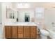 Bathroom featuring double sinks, a bathtub, and a view into the closet at 329 Gemstone Hill Ave, North Las Vegas, NV 89031