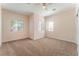 Spacious carpeted bedroom with ceiling fan and multiple windows for natural light at 329 Gemstone Hill Ave, North Las Vegas, NV 89031