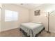 Cozy bedroom with a double bed, window and carpeted floors at 329 Gemstone Hill Ave, North Las Vegas, NV 89031