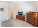 Bedroom with carpet, dressers, a television, and an open doorway at 329 Gemstone Hill Ave, North Las Vegas, NV 89031