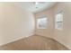 Neutral bedroom features carpet flooring, a window, and ample natural light at 329 Gemstone Hill Ave, North Las Vegas, NV 89031