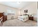 Cozy bedroom featuring carpet, a large window, and traditional furnishings at 329 Gemstone Hill Ave, North Las Vegas, NV 89031