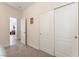 Bright bedroom featuring neutral carpeting, sliding closet doors, and an adjoining open door at 329 Gemstone Hill Ave, North Las Vegas, NV 89031