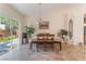Cozy dining area featuring a table with chairs, access to the backyard, and neutral walls at 329 Gemstone Hill Ave, North Las Vegas, NV 89031